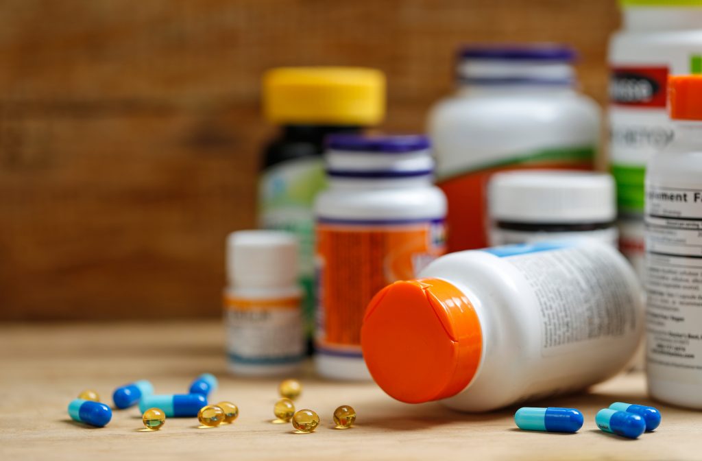Does Turkesterone Actually Work? A Worthwhile Look at the Science 4 medicine bottles tablets wooden desk